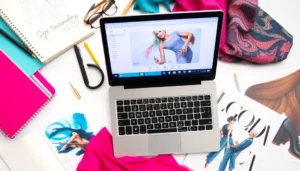 A creative workspace featuring fashion sketchbooks, fabric samples, and a laptop.